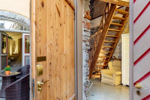 a wooden door leading into a room with a staircase at Meriton Old Town Garden Hotel in Tallinn