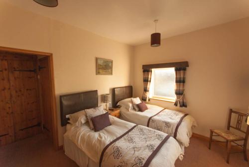 Llit o llits en una habitació de Greyfield Farm Cottages