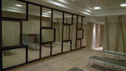 a room with mirrors and a chair in it at Iris Hotel & Spa in Canakkale