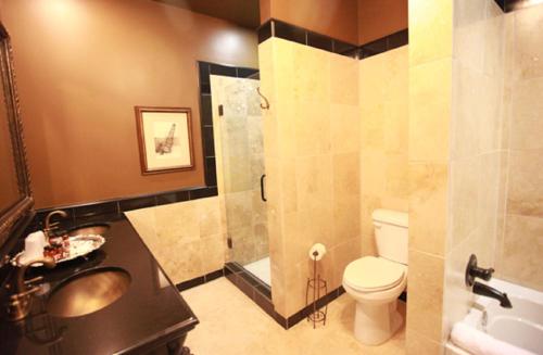 a bathroom with a sink and a toilet and a shower at The Campbell Hotel in Tulsa