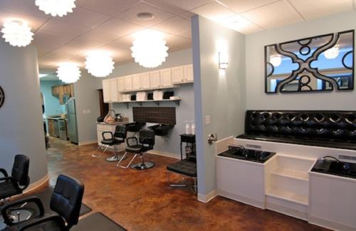 a hair salon with chairs and a barber shop at The Campbell Hotel in Tulsa