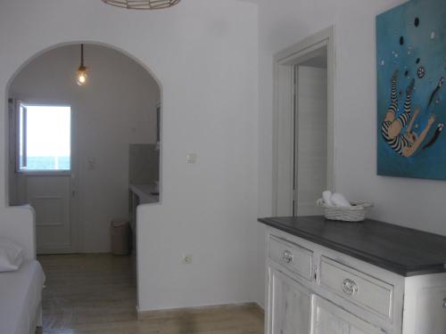 a living room with a kitchen with a counter top at Daphne in Naousa
