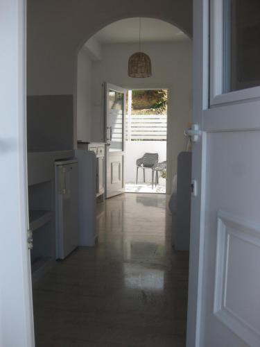 an open door to a kitchen with a table at Daphne in Naousa
