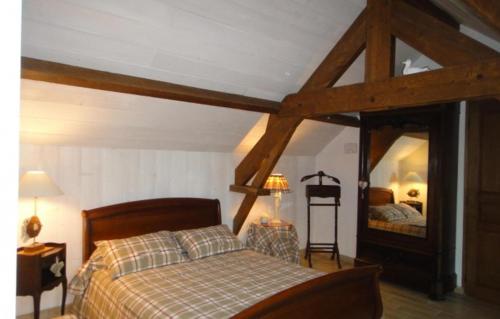 a bedroom with a bed and a large mirror at Gîte La Bourgetterie Fontenay sur Mer in Fontenay-sur-Mer