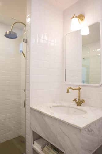 a bathroom with a sink and a mirror at Zivi Nimman in Chiang Mai