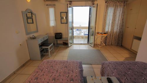 a living room with a glass door leading to a balcony at Glafki in Limne