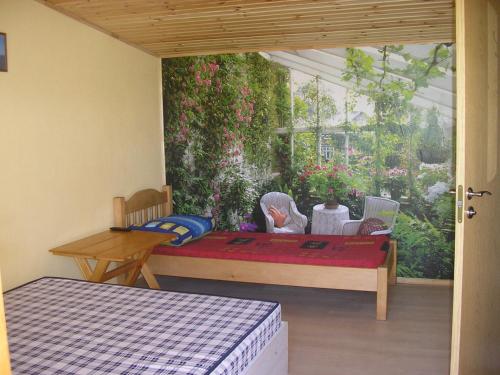 a patio with a table and a bed in a room at Žuvėdrų g. 27 in Šventoji