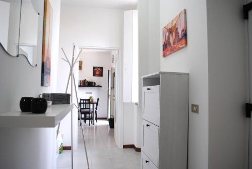 a kitchen with a refrigerator and a dining room at Bnbook Cascina Crennese in Gallarate