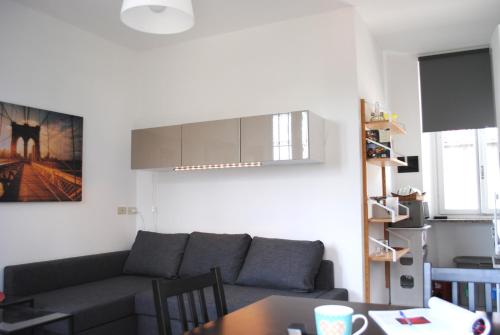 a living room with a couch and a table at Bnbook Cascina Crennese in Gallarate