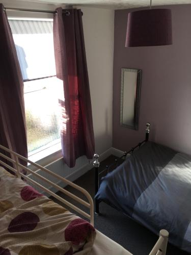 a bedroom with a bed and a window at The Bunkroom in Chester