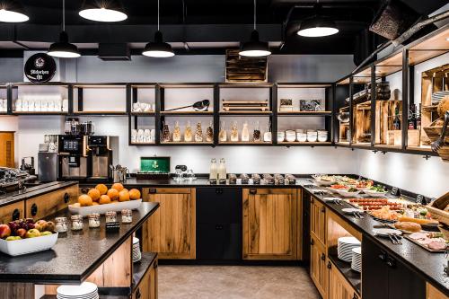 a large kitchen with lots of food on the counters at Best Western Plus Parkhotel Velbert in Velbert