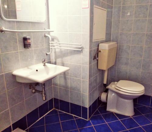 a bathroom with a toilet and a sink at Hotel Nap in Budapest