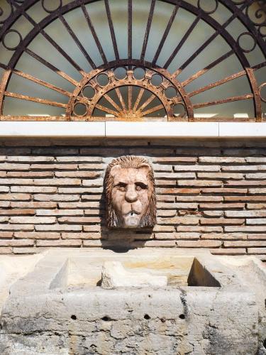 a statue of a lion on a brick wall at La Brigata Apartments Orange House in Cavallino-Treporti