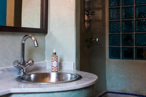 a bathroom sink with a soap dispenser on it at Dar Sohane in Marrakesh