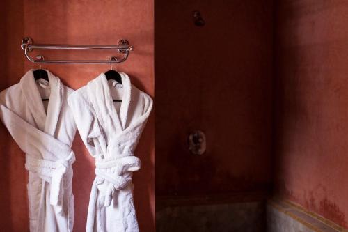 a robe hanging on a towel rack in a bathroom at Dar Sohane in Marrakesh
