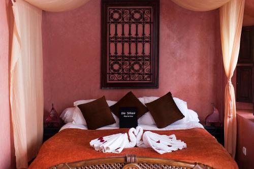 a bedroom with a bed with towels on it at Dar Sohane in Marrakesh