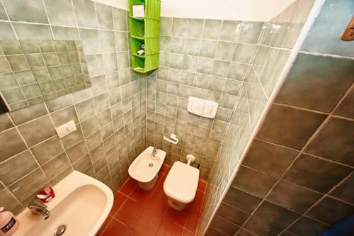 a bathroom with a sink and a toilet at Borgo S.Maria Di Vulci in Montalto di Castro