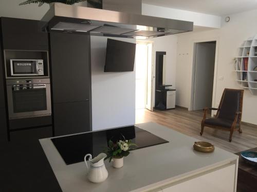 a kitchen with a black and white kitchen at Modern Flat Lecce ++ in Lecce