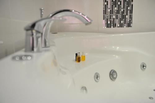 a white bathroom sink with a faucet at B&B Villa Pipacs in Feketić