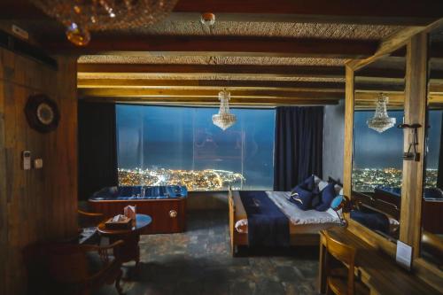 a bedroom with a bed and a view of a city at Bay Lodge Boutique Hotel in Jounieh
