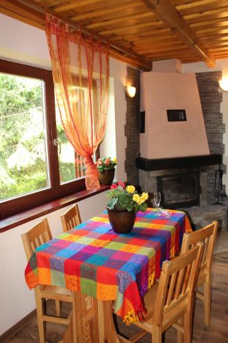 a dining room with a table with a colorful table cloth at Zawoja Chaty Górskie D4 in Zawoja