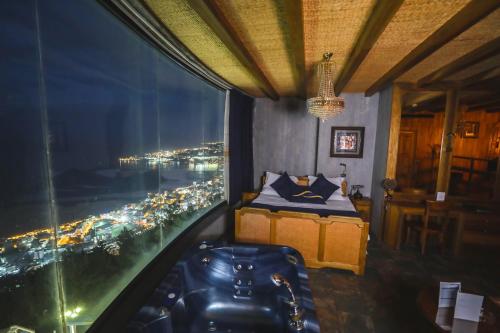 a bedroom with a bed and a view of a city at Bay Lodge Boutique Hotel in Jounieh