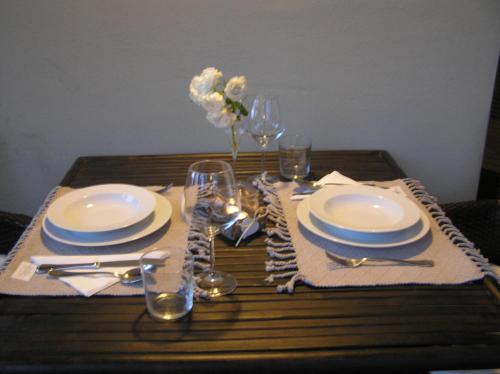 a table with plates and glasses on a wooden table at Atelier in Portogruaro