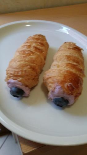 two pastries on a white plate on a table at La Casa Del Grillo 1 in Aosta