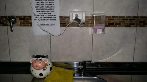 a cow toy sitting on top of a sink at Cabañas Kehuen in Cordoba