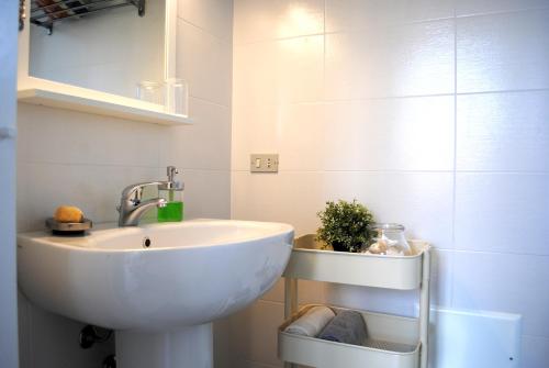 a bathroom with a white sink in a room at Bnbook Cascina Crennese in Gallarate