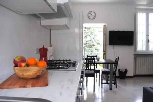 a kitchen with a bowl of fruit on a counter at Bnbook Cascina Crennese in Gallarate