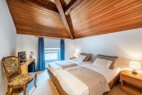 a bedroom with a bed and a wooden ceiling at Albergo Ristorante Svizzero in Capolago