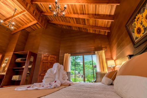 a bedroom with a large bed and a window at Hotel El Silencio del Campo in Fortuna