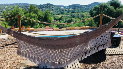 a hammock with a view of a mountain at Villa Monte da Alfarrobeira in Estói