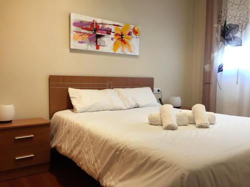 a bedroom with a bed with white sheets at P&C Areny in Canillo