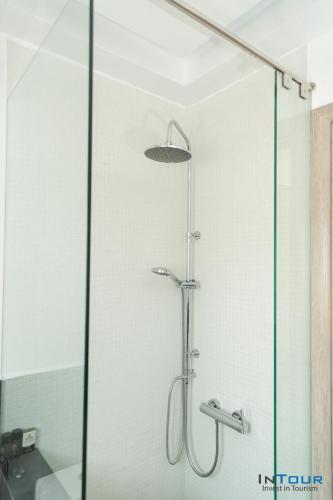 a shower with a glass door in a bathroom at Art point under Acropolis in Athens