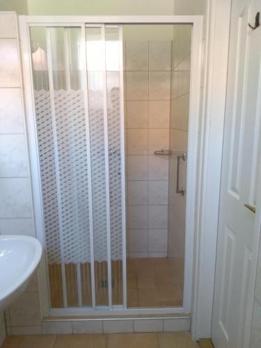 a shower with a glass door in a bathroom at Siófokroom24 in Siófok