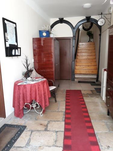 a red carpet in a room with a table and stairs at Apartments Paris in Umag