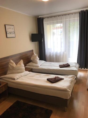 Una cama o camas en una habitación de Pensjonat Kasia i Michał