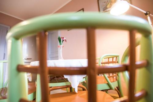 a table and chairs with a vase with a flower on it at Penzion Šatlava in Nové Město nad Metují