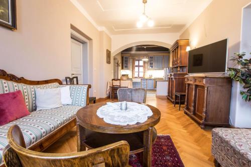 a living room with a couch and a table at Penzion Šatlava in Nové Město nad Metují