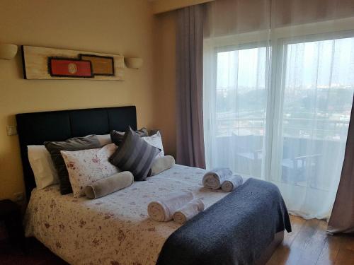 a bedroom with a bed with towels on it at Spectacular Views Penthouse Apartment in Vila Nova de Gaia