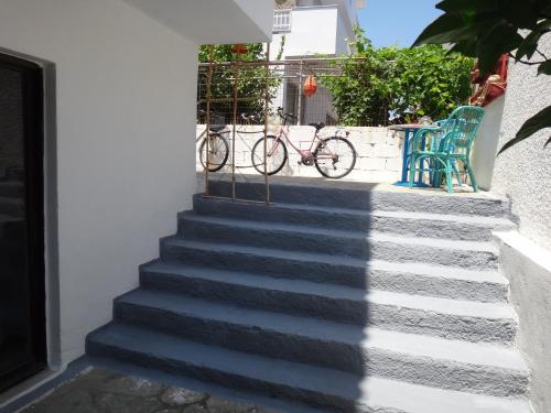 a set of stairs with a bike parked next to a building at Amfi Apartments in Kardamaina