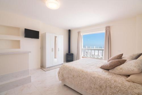 a bedroom with a large bed and a large window at Villa Mariemne VIP in Playa Honda