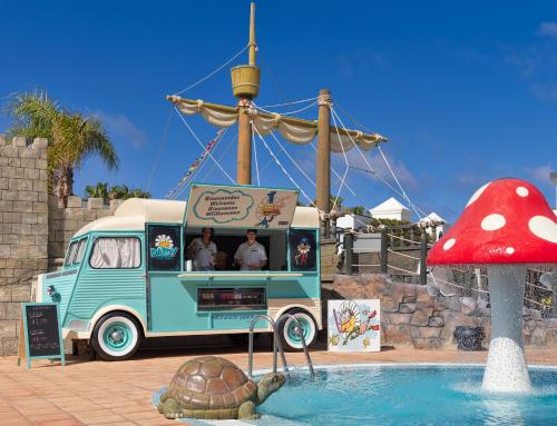 a turtle in the water next to a food truck at H10 Rubicón Horizons Collection in Playa Blanca