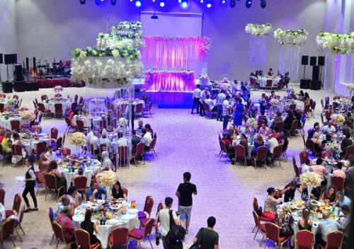 a group of people sitting at tables in a banquet hall at Euphoria Batumi Convention & Casino Hotel in Batumi