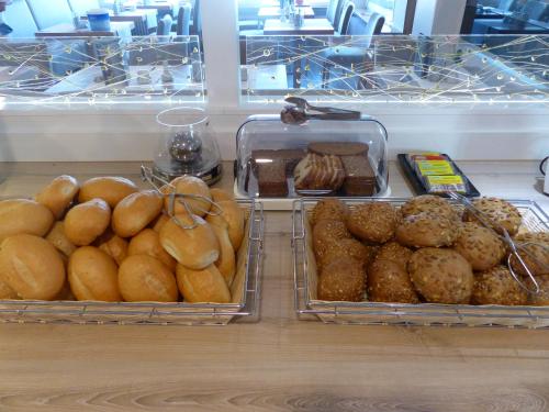 two trays of different types of bread and pastries at Pension An Bord in Varel