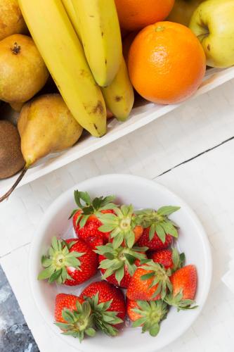 a bowl of strawberries and bananas and other fruit at City Hotel & Suites in Foligno