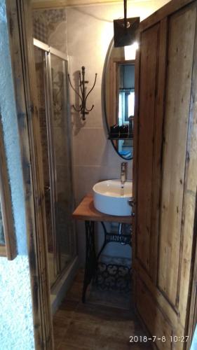 a bathroom with a sink and a mirror at Villa Haris in Sarti