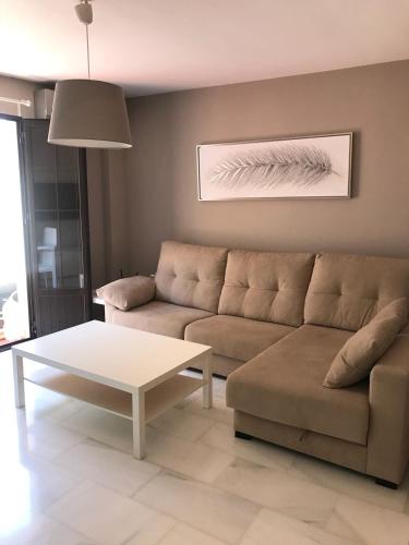 a living room with a couch and a coffee table at Apartamento Plaza del Socorro in Ronda